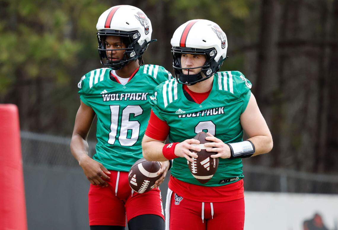 N.C. State quarterbacks Grayson McCall (2) and CJ Bailey (16) prepare to run a drill during the Wolfpack’s first spring practice Tuesday, Feb. 27, 2024.