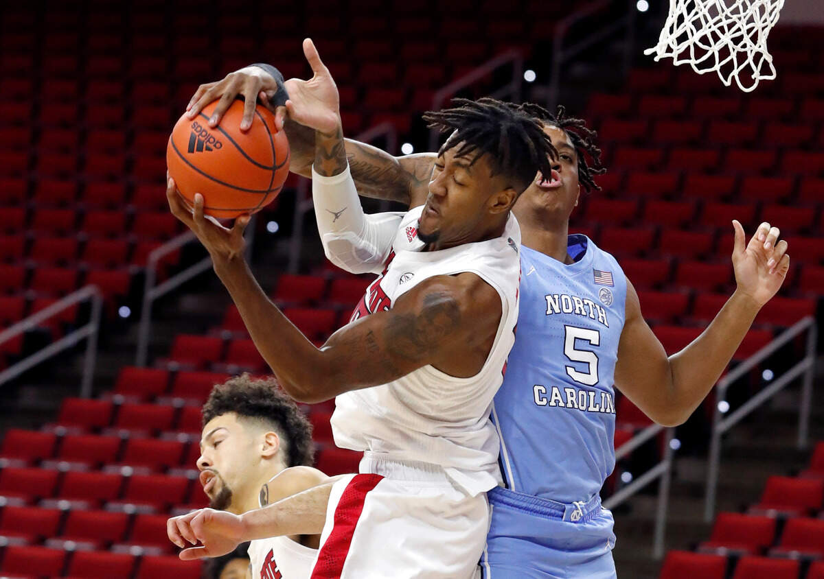 N.C. State’s Manny Bates (15) pulls in a rebound from North Carolina’s Armando Bacot (5) during the first half of N.C. State’s game against UNC at PNC Arena in Raleigh, N.C., Tuesday, December 22, 2020.