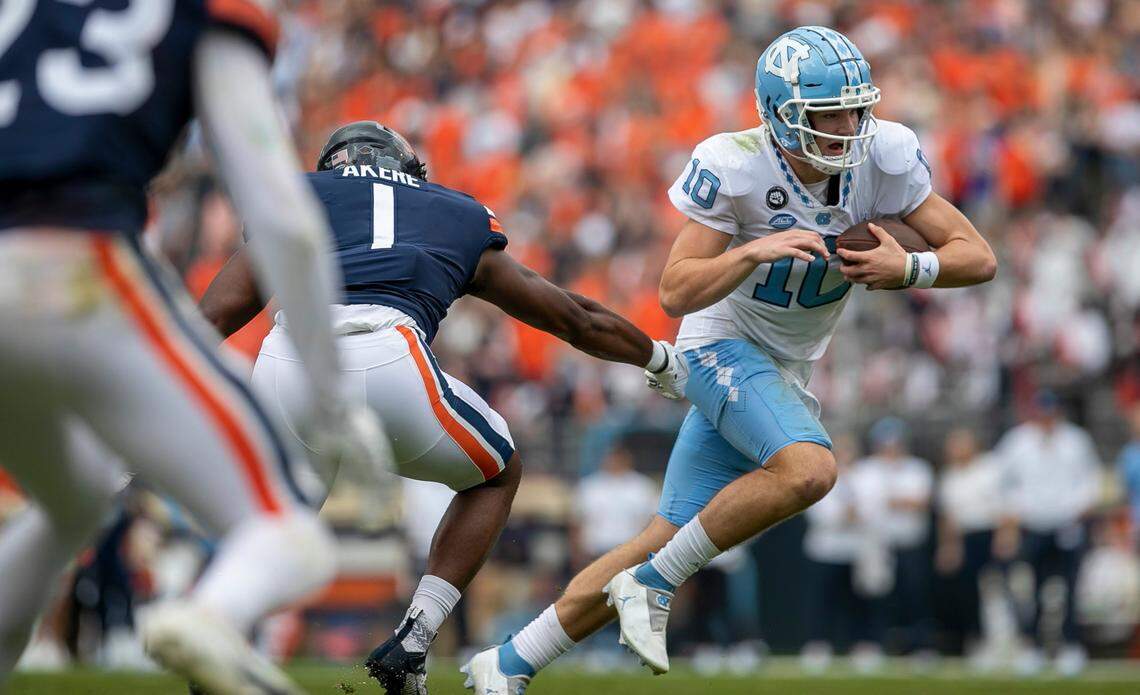 North Carolina quarterback Drake Maye (10) rushes for 11-yards to set up the Tar Heels’ touchdown in the second quarter against Virginia on Saturday, November 5, 2022 at Scott Stadium in Charlottesville, Va.
