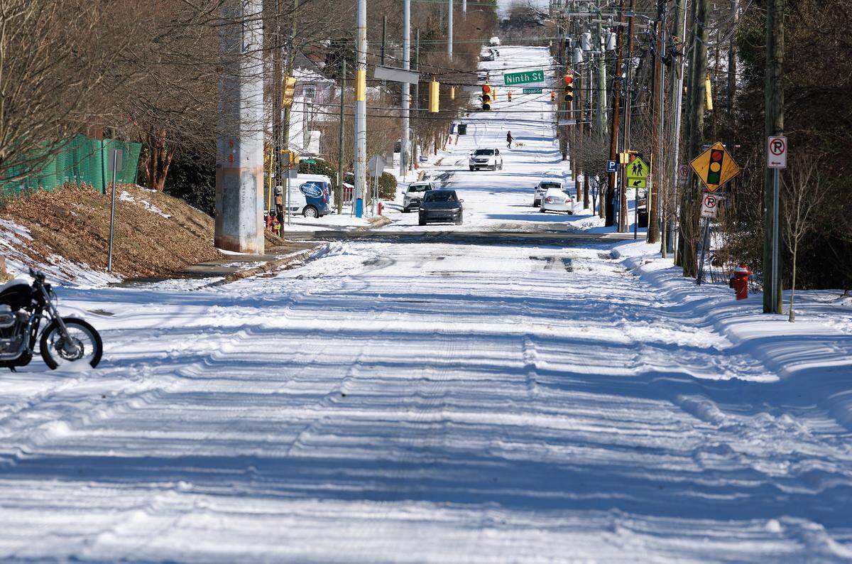 Snow covers portions of Green Street on Sunday, Feb. 1, 2026, in Durham, N.C.