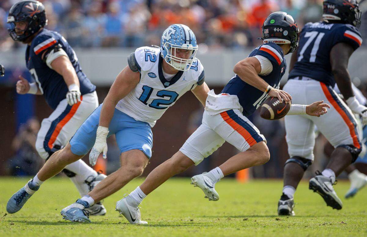 North Carolina defensive lineman Beau Atkinson (12) pressures Virginia quarterback Anthony Colandrea (10) in the second quarter on Saturday, October 26, 2024 at Scott Stadium in Charlottesville, Va.
