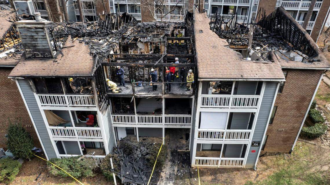 Firefighters and investigators with the Cary Fire Department works at the scene of a three-story apartment fire on Harlon Drive at the Aurella Cary apartments Tuesday, March 8, 2022. The Monday afternoon fire killed a child and left three people hospitalized according to Cary officials.
