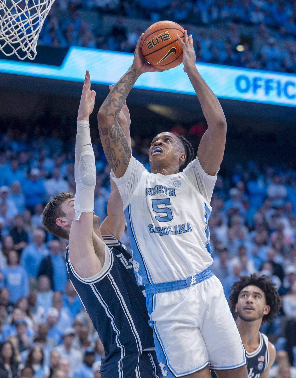 North Carolina’s Armando Bacot (5) muscles his way to the basket against Duke’s Kyle Filipowski (30) in the second half on Saturday, February, 3, 2024 at the Dean E. Smith Center in Chapel Hill, N.C. Bacot led all scores with 25 points in the Tar Heels’ 93-84 victory.