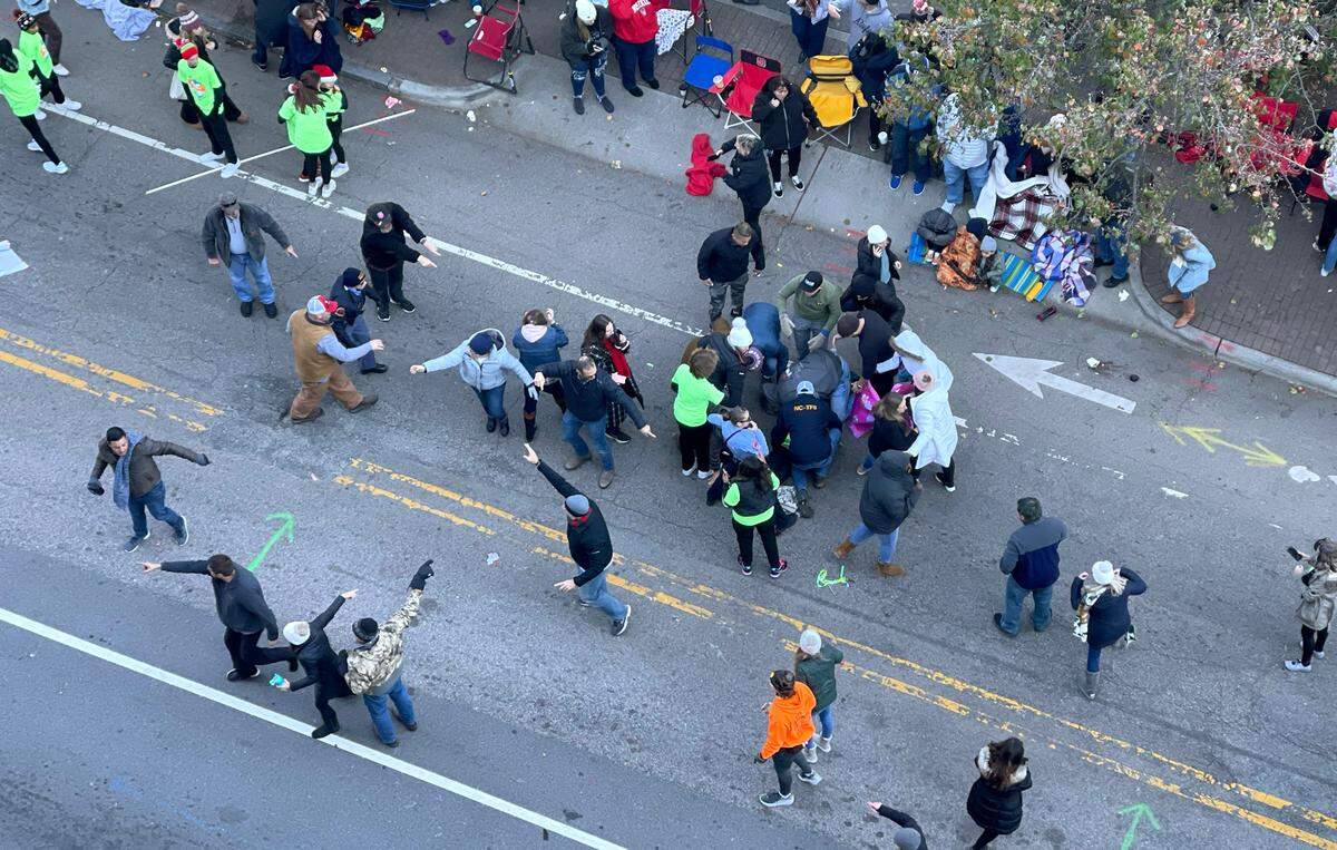 Personnel rush to where a person was injured during the Raleigh Christmas Parade on Hillsborough Street in Raleigh, N.C., Saturday, Nov. 19, 2022.