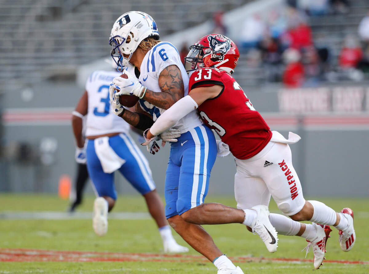 N.C. State’s Isaac Duffy (33) tackles Duke wide receiver Eli Pancol (6) during the first half of N.C. State’s game against Duke at Carter-Finley Stadium in Raleigh, N.C., Saturday, Oct. 17, 2020.