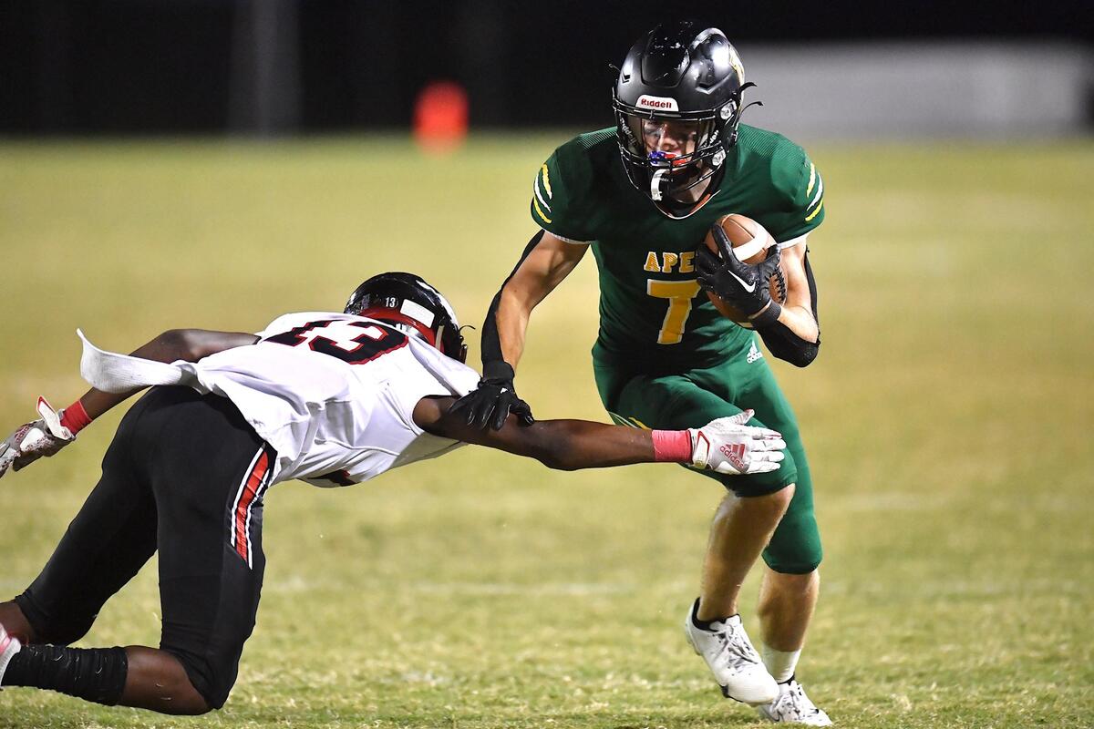 Apex wide receiver Jack Welch (7) runs for the first down against Middle Creek’s Christian Prince (13) during the second half. The Apex Cougars and the and the Middle Creek Mustangs met in a football game in Apex, N.C. on October 14, 2022.