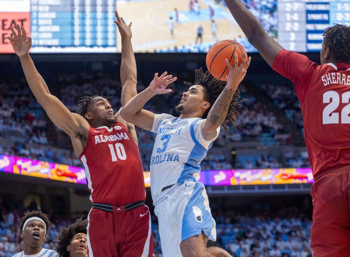 North Carolina guard Elliot Cadeau (3) drives to the basket against Alabama guard Labaron Philon (0) in the first half on Wednesday, December 4, 2024 at the Smith Center in Chapel Hill, N.C.