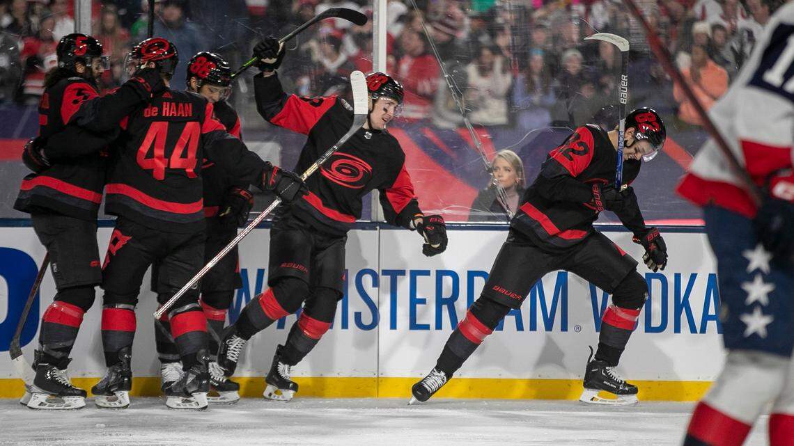 Carolina Hurricanes’ Jesperi Kotkaniemi (82) and his teammates react after scoring on Washington Capitals’ goalie Darcy Kuemper (35) to take a 1-0 lead in the first period during the Stadium Series game on Saturday, February 18, 2022 at Carter-Finley Stadium in Raleigh, N.C.