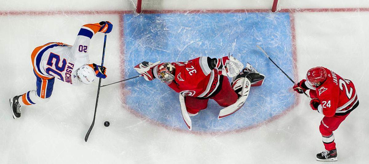 Carolina Hurricanes goalie Antii Raanta (32) defends New York Islanders’ Hudson Fasching (20) during the third period in Game 2 of their Stanley Cup series on Wednesday, April 19, 2023 at PNC Arena in Raleigh, N.C.