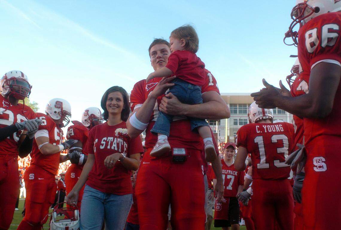 N.C. State’s Philip Rivers carries his daughter Halle as his wife Tiffany joins him as Rivers walks through the Wolfpack players to receive a framed jersey. Rivers’ jersey was retired Saturday as one of only eight players to receive the honor in NC State history. Rivers played his final home game as the quarterback for the North Carolina State Wolfpack against Maryland Saturday.