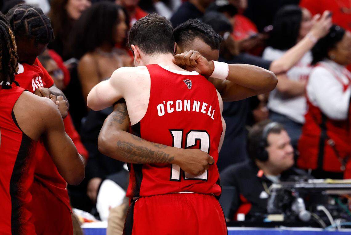 N.C. State’s DJ Horne (0) hugs Michael O’Connell (12) as time runs down in N.C. State’s 84-76 victory over UNC in the championship game of the 2024 ACC Men’s Basketball Tournament at Capital One Arena in Washington, D.C., Saturday, March 16, 2024.