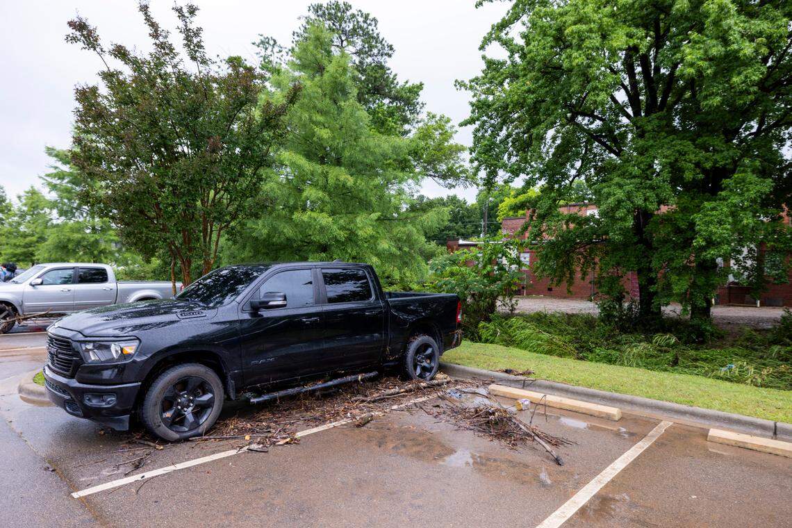 Flood debris surrounds a pickup truck near Little Buffalo Creek in downtown Sanford on Saturday, June 5, 2025. Flash flooding hit the city Thursday afternoon, blocking downtown streets, causing several car accidents and trapping residents in parts of town.