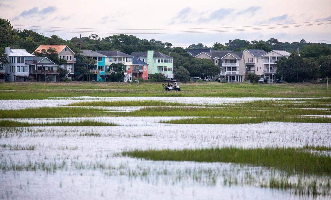 A golf cart crosses the Cyprus Avenue causeway that joins Murrells Inlet with Garden City Beach. The causeway floods frequently during storm events. Aug. 11, 2021.