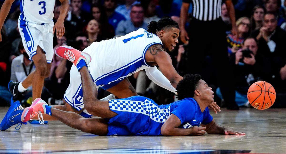 Kentucky’s Sahvir Wheeler, below, fights for control of the ball with Duke’s Trevor Keels during the first half of an NCAA college basketball game Tuesday, Nov. 9, 2021, in New York.