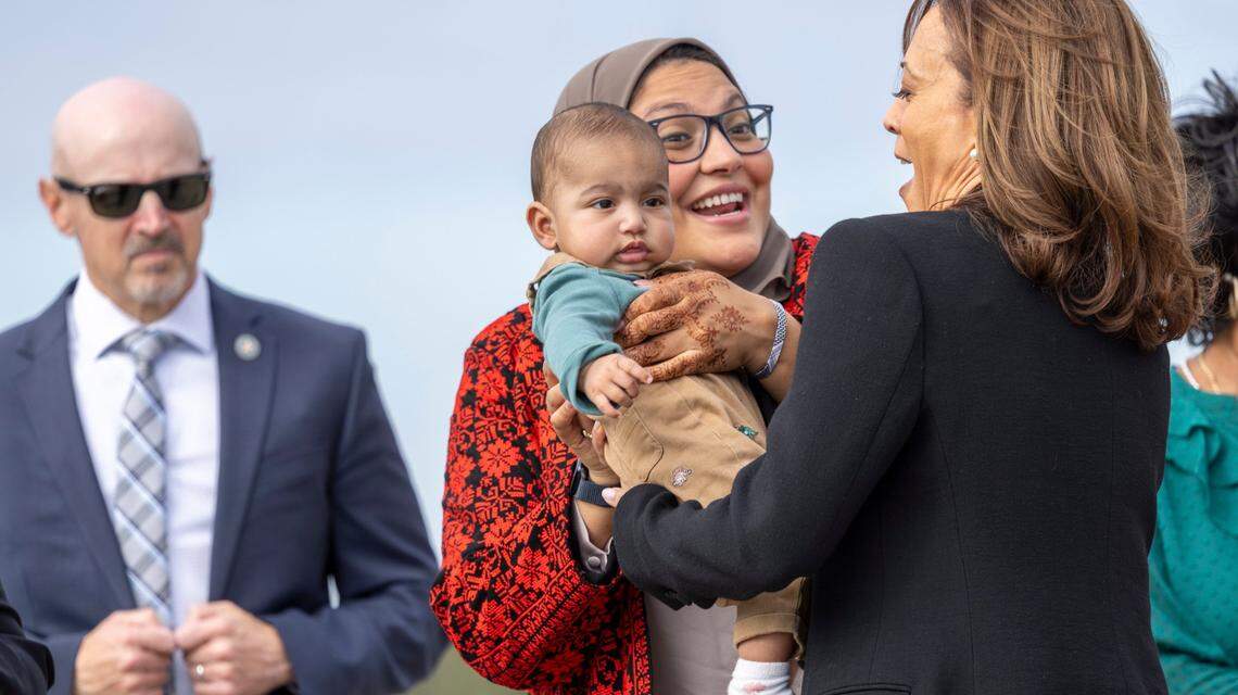 Vice President Kamala Harris is greeted by Durham County Commissioner Nida Allam and her child on the tarmac at Raleigh-Durham International Airport prior to a campaign stop at Coastal Credit Union Music Park at Walnut Creek in Raleigh on Wednesday, October 30, 2024.