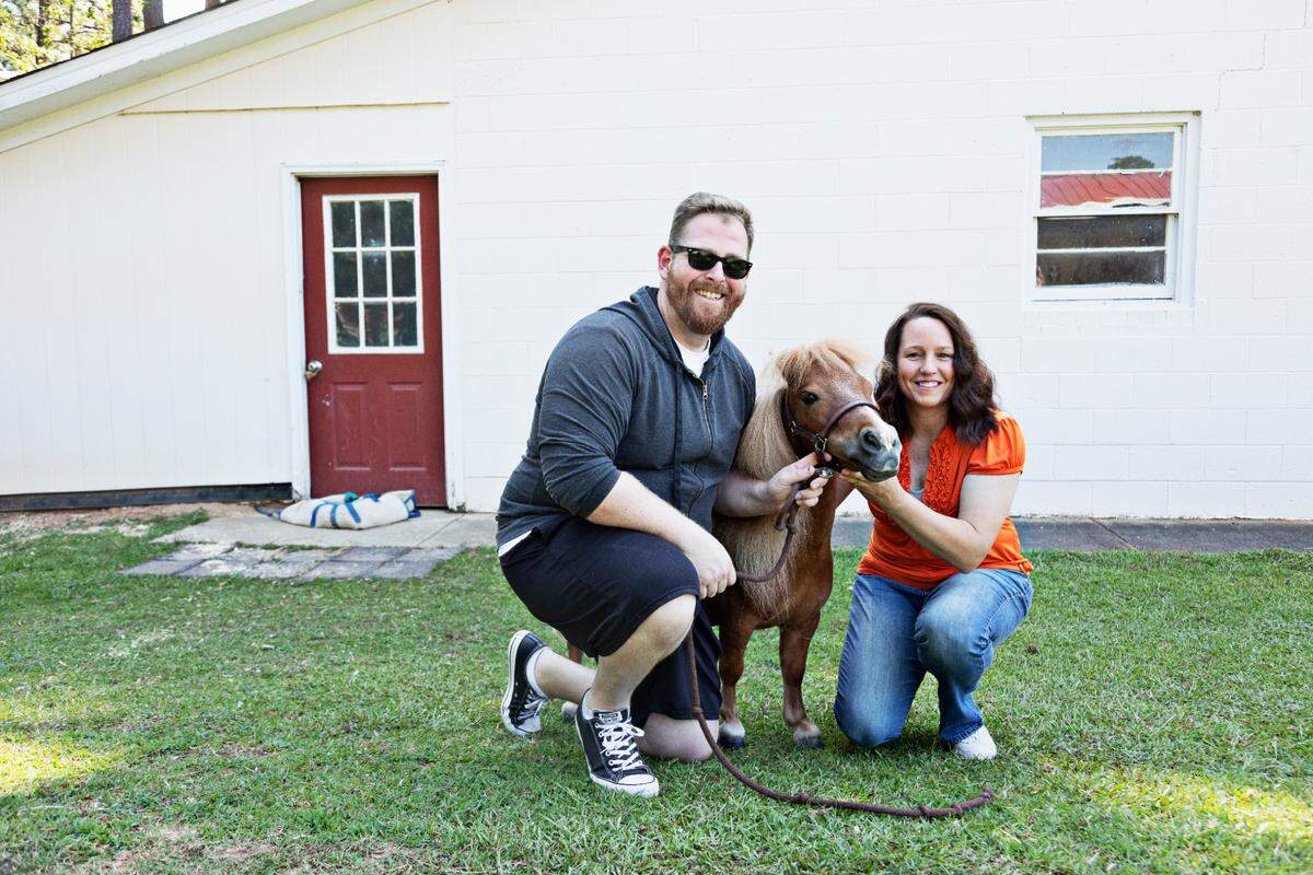 Therapy mini horse, Kiwi, with Jacques Belliveau, left, and his owner, Tara Needham, right, at Needham’s Raleigh home in August 2021. Kiwi recently co-starred in “Reggie” with Belliveau in a film that addresses mental health issues.