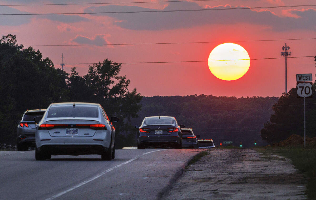 The sun sets over U.S. 70 in Clayton on June 29, 2026. A heat wave will send temperatures over 100 degrees through the July 4 weekend.