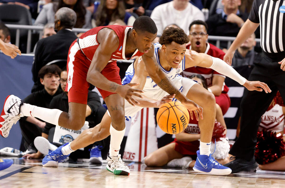 Duke’s Wendell Moore Jr. (0) and Arkansas’ Davonte Davis (4) go after the ball during the second half of Duke’s 78-69 victory over Arkansas in the NCAA Tournament West Regional finals at the Chase Center in San Francisco, Calif., Saturday, March 26, 2022.