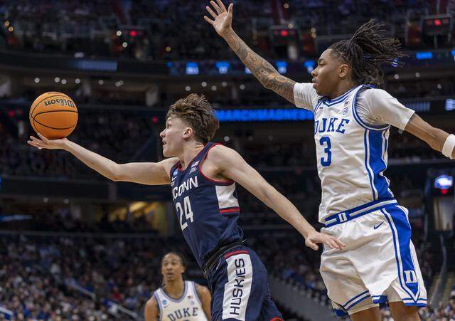 Connecticut guard Braylon Mullins (24) breaks to the basket against Duke forward Isaiah Evans (3) in the second half on Sunday, March 29, 2026, in the NCAA East Regional Championship, at Capital One Arena in Washington, 