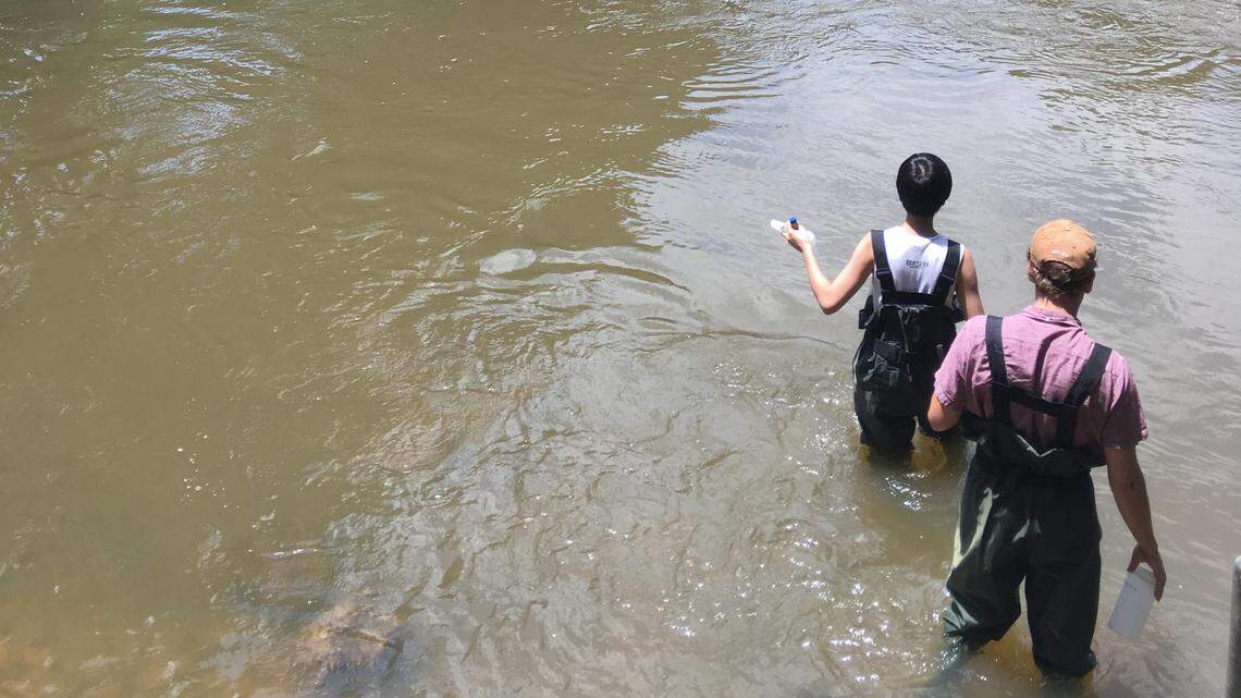 The Town of Pittsboro is suing 20 manufacturers of so-called forever chemicals, alleging that they knowingly sold harmful substances that contaminated the Haw River from which the town draws its drinking water. Here, Duke University researchers are shown drawing water samples from the Haw in 2019 to test for PFAS.