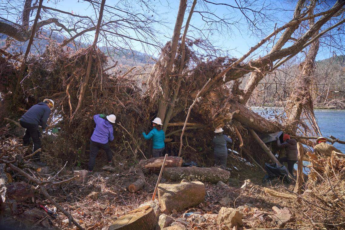 Carolina Mountain Club volunteers help clear downed trees along the French Broad River near Hot Springs in November 2024. The town relies on tourism, especially hikers along the Appalachian Trail.