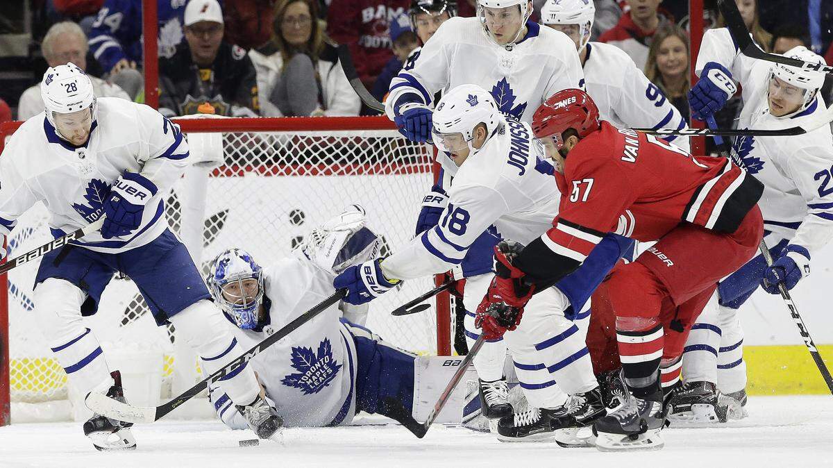 Carolina Hurricanes’ Trevor van Riemsdyk (57) shoots and scores against Toronto Maple Leafs goalie Frederik Andersen, of Denmark, while Andreas Johnsson (18), of Sweden, and Connor Brown (28) defend during the first period of an NHL hockey game in Raleigh, N.C., Wednesday, Nov. 21, 2018.