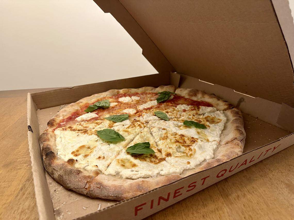 A 50/50 pizza from Capital Pizza Box with ricotta, basil and honey.