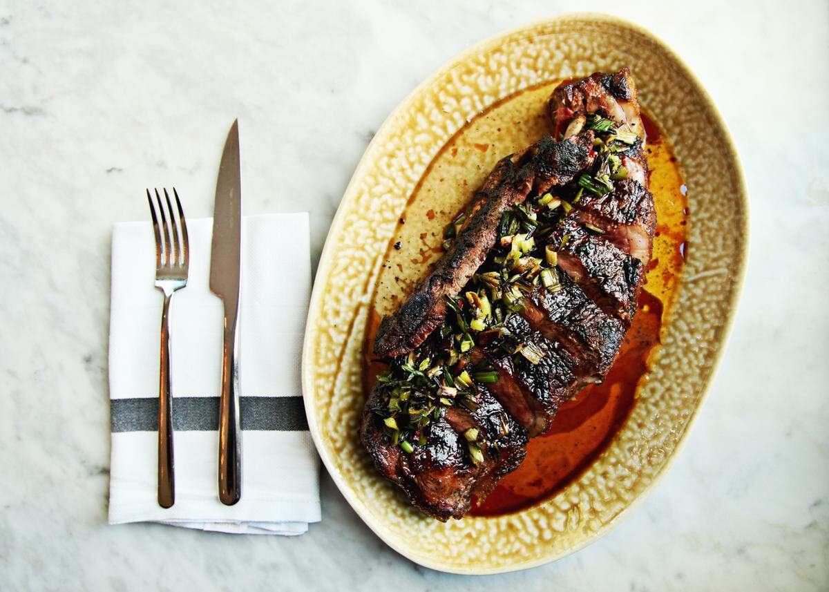 Dry-aged steak, spring onion and chimichurri from the menu at Death & Taxes in downtown Raleigh.