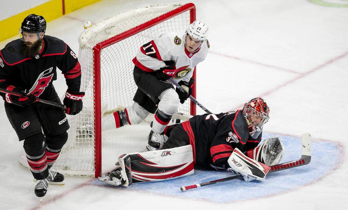 Ottawa’s Ridly Greig (17) and Carolina Hurricanes’ goalie Antii Raanta (32) eye the puck after a save by Raanta during the second period on Tuesday, April 4, 2023 at PNC Arena in Raleigh, N.C.
