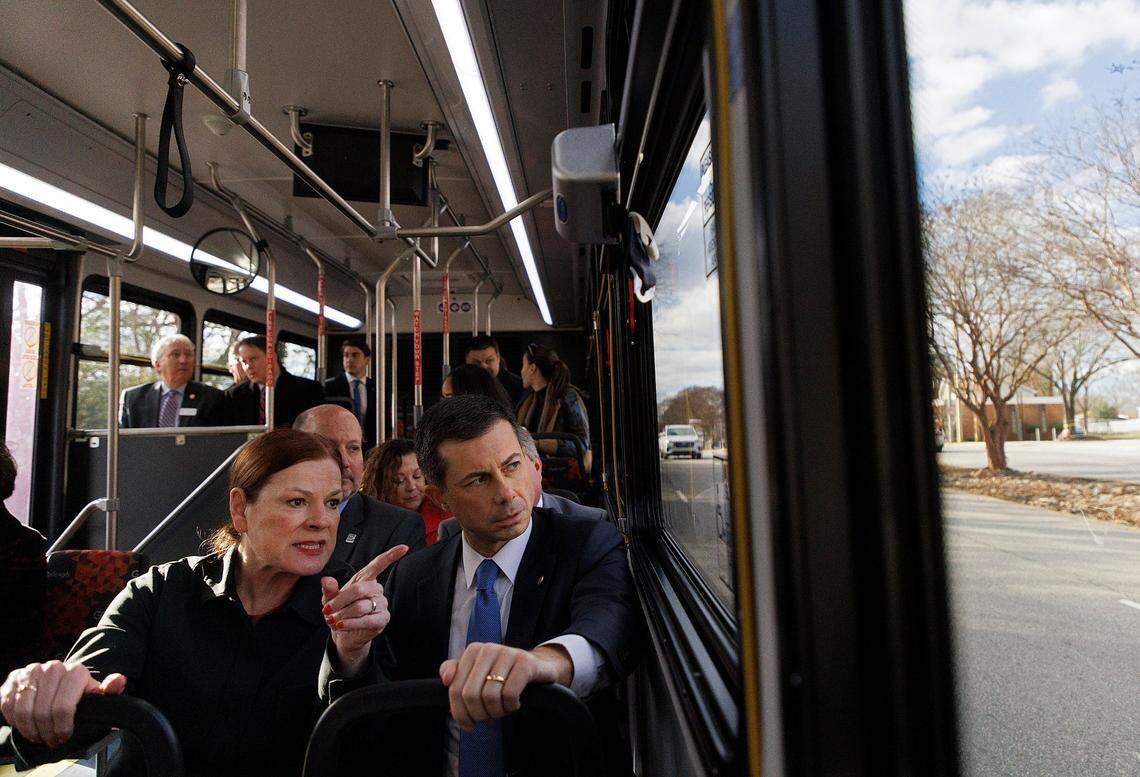 Raleigh Mayor Mary-Ann Baldwin talks with U.S. Transportation Secretary Pete Buttigieg during a tour of the first leg of the city’s planned bus rapid transit system on Monday, Dec. 11, 2023.