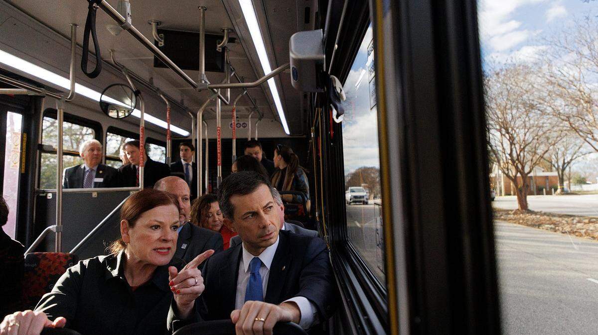 Raleigh Mayor Mary-Ann Baldwin talks with U.S. Transportation Secretary Pete Buttigieg on Dec. 11, 2023 during a tour of the city’s planned bus rapid transit line on New Bern Avenue. Buttigieg said the city must work to make sure that residents along the line don’t get priced out by gentrification.