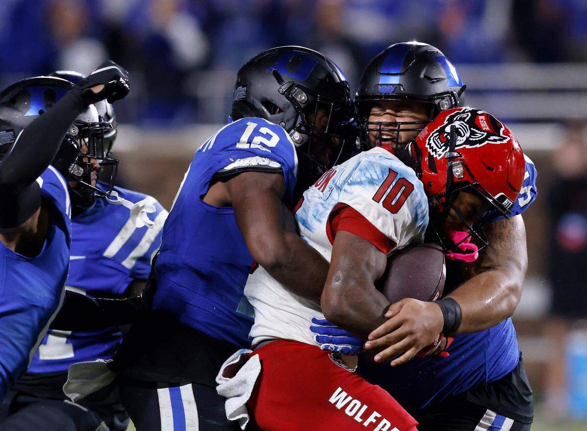 Duke’s defense surrounds N.C. State’s Kevin Concepcion during the second half of the Blue Devils’ 24-3 win on Saturday, Oct. 14, 2023, at Wallace Wade Stadium in Durham, N.C.