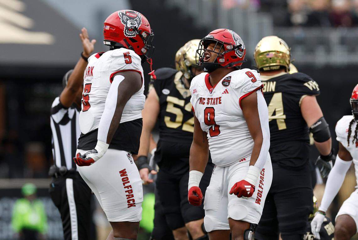 N.C. State defensive end Savion Jackson (9) celebrates with C.J. Clark (5) after Wake Forest quarterback Mitch Griffis (12) was stopped during the first half of N.C. State’s game against Wake Forest at Allegacy Stadium in Winston-Salem, N.C., Saturday, Nov. 11, 2023.