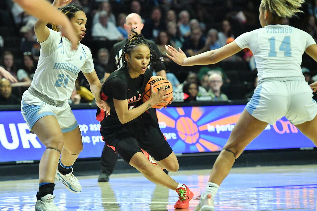 Rolesville’s Caitlyn Jones (5) drives to the lane against Hoggard’s YaYa Graham (24) and Tristan Shivers (14) during the second half of the NCHSAA 4A East Regional Finals. Rolesville and Hoggard met in the NCHSAA 4A East Regional Championship game in Winston-Salem, N.C. on March 14, 2024.