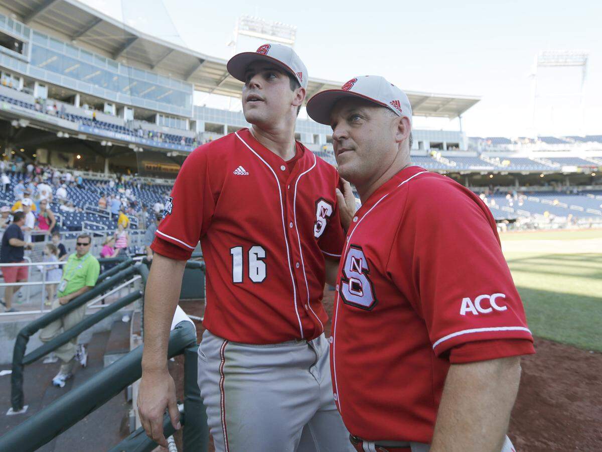 N.C. State's Elliott Avent and Carlos Rodon (16) look back to the crowd after N.C. State's 8-1 victory over UNC in the College World Series Sunday, June 16, 2013, at TD Ameritrade Park in Omaha, Nebraska.  