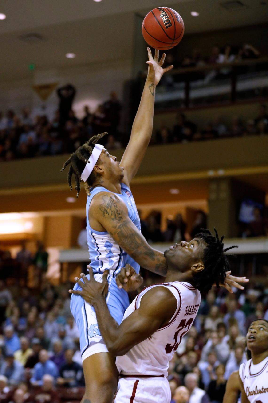 North Carolina’s Armando Bacot (5) shoots over College of Charleston’s Osinachi Smart (33) during the first half of an NCAA college basketball game Tuesday, Nov. 16, 2021, in Charleston, S.C. (AP Photo/Mic Smith)