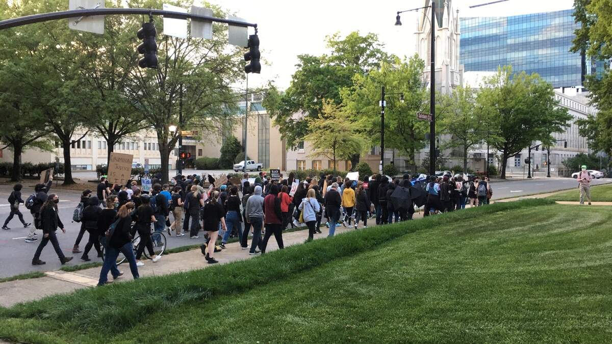 A group of demonstrators march around the N.C. State Capitol Saturday evening, April 17, 2021 in Raleigh.