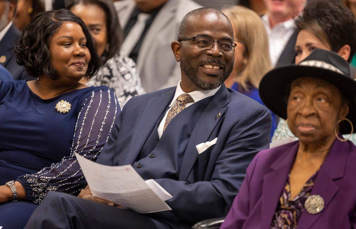 Dr. Robert Taylor, flanked by his wife Vivian Taylor, left and mother Josephine Taylor, smiles after being introduced as Wake County’s new superintendent of schools on Friday, September 29, 2023 in Cary, N.C.