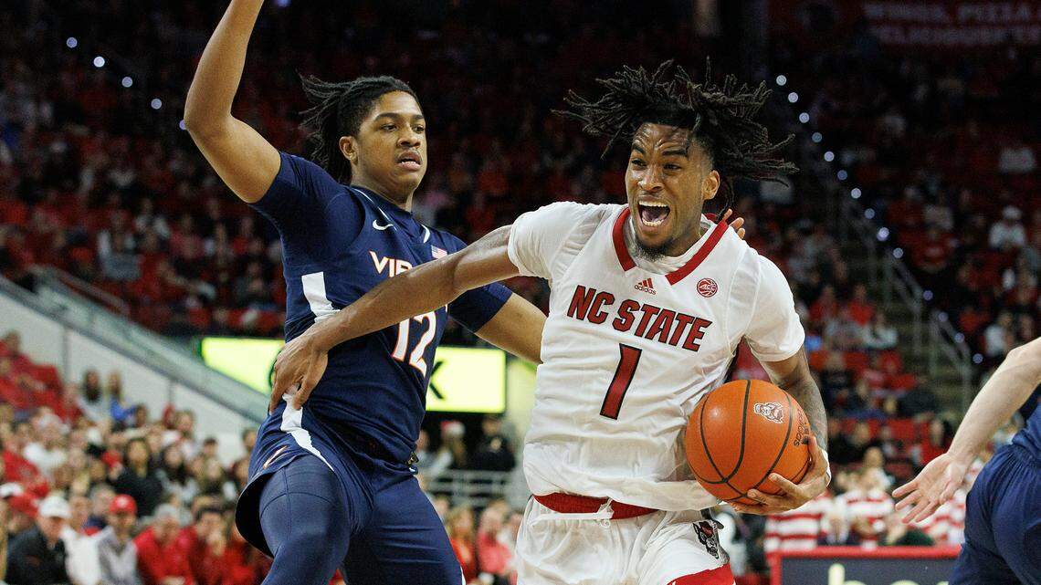 N.C. State’s Jayden Taylor is fouled as he drives by Virginia’s Elijah Gertrude during the second half of the Wolfpack’s 76-60 win on Saturday, Jan. 6, 2024, at PNC Arena in Raleigh, N.C.
