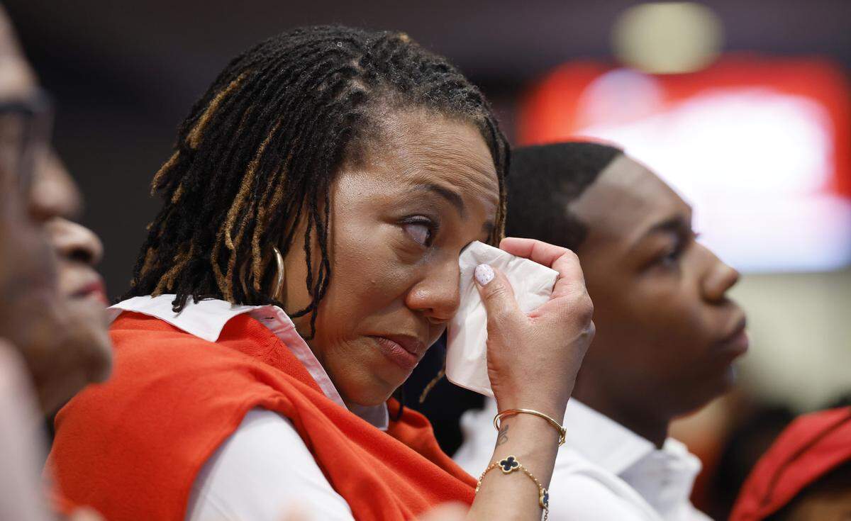 Justin Gainey’s wife Courtney wipes a tear from her eye as Justin speaks during a press conference at the Lenovo Center where Gainey was officially introduced as the new head basketball coach Wednesday, April 1, 2026.