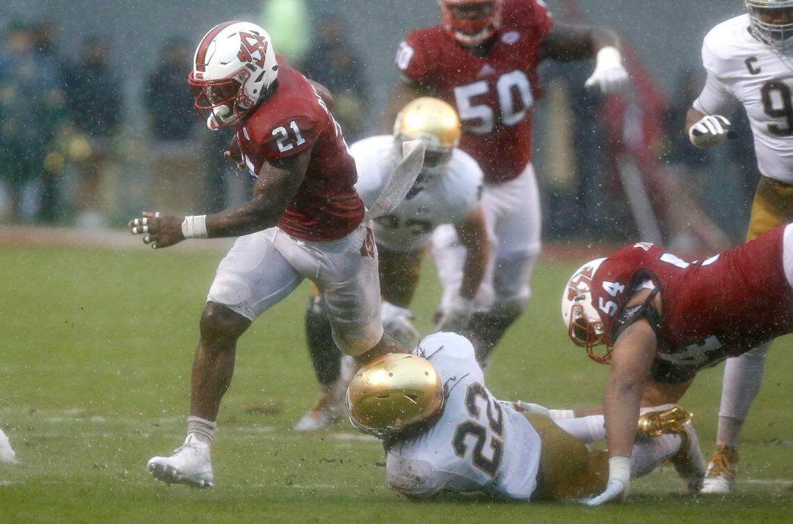 N.C. State running back Matt Dayes (21) escapes from Notre Dame linebacker Asmar Bilal (22) during the first half of the Wolfpack’s game against Notre Dame at Carter-Finley Stadium in Raleigh, N.C., Saturday, Oct. 8, 2016.