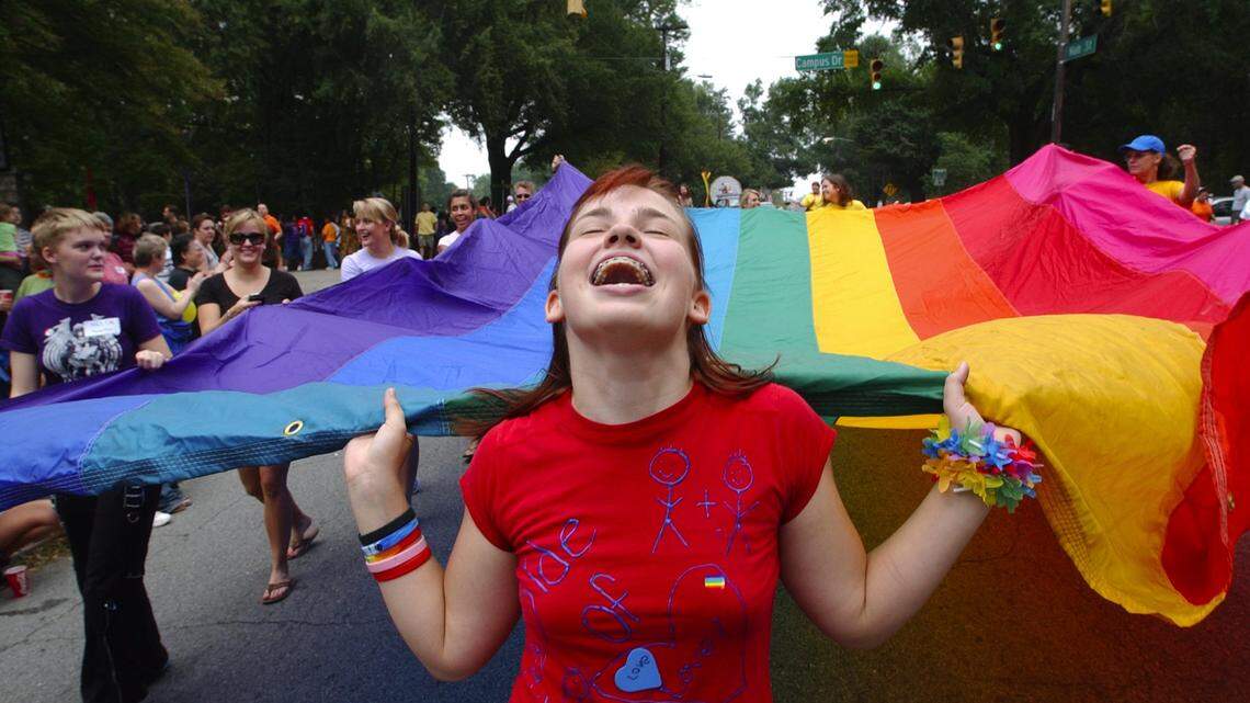 Ariel Frawley of Wake Forest helps carry the large diversity flag at the 2005 NC Gay Pride Parade in Durham, NC. The first Pride parade in Durham was June 27, 1981, and it was called Our Day Out.
