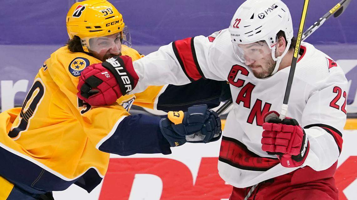 Nashville Predators’ Roman Josi (59) and Carolina Hurricanes’ Brett Pesce (22) battle for position in the first period of an NHL hockey game Tuesday, March 2, 2021, in Nashville, Tenn. (AP Photo/Mark Humphrey)