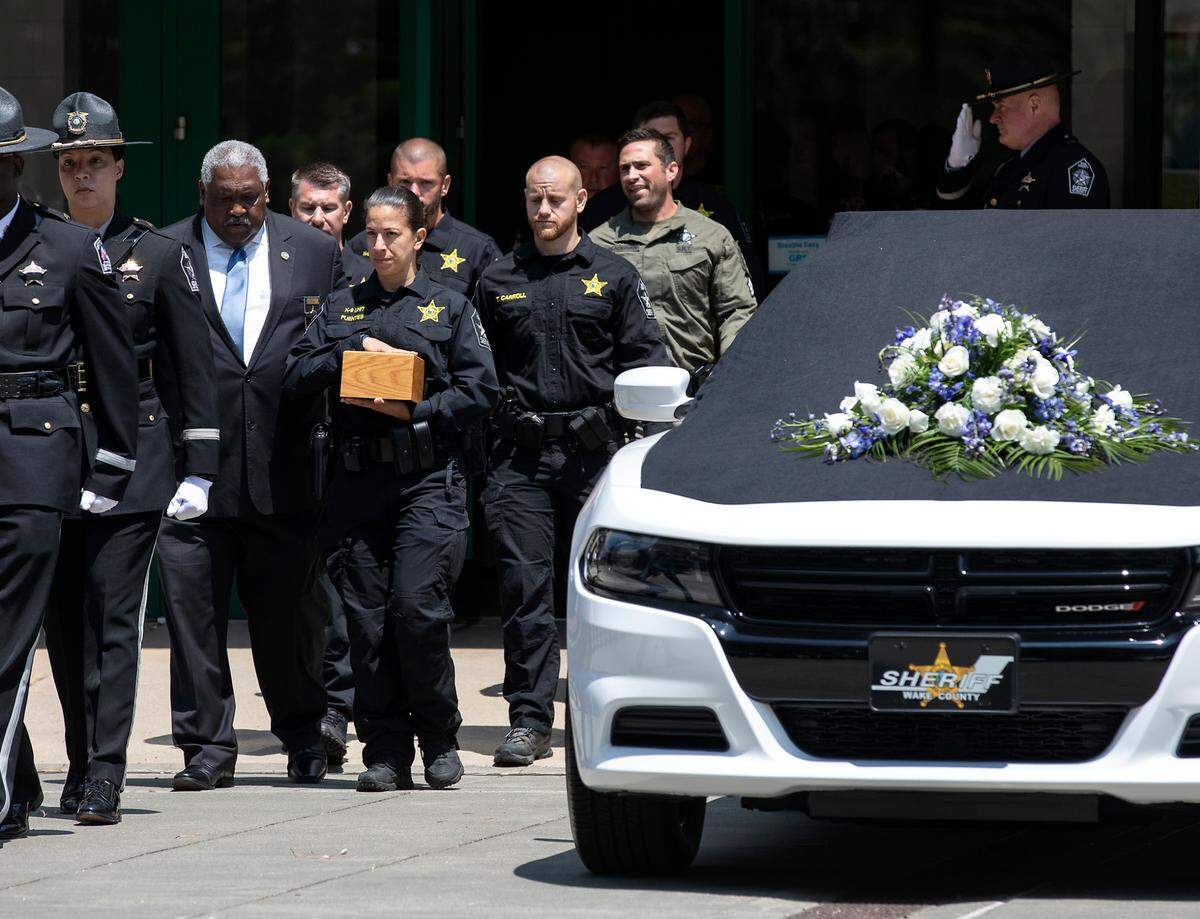 Master Deputy Maria Fuentes walks alongside Wake County Sheriff Willie Rowe following a memorial service for K9 Santos, a Wake County sheriff’s dog, at the Kerr Scott Building on Wednesday, June 14, 2023, in Raleigh, N.C. K9 Santos, a German shepherd, was accidentally shot and killed by a Knightdale police officer after a traffic stop in May.