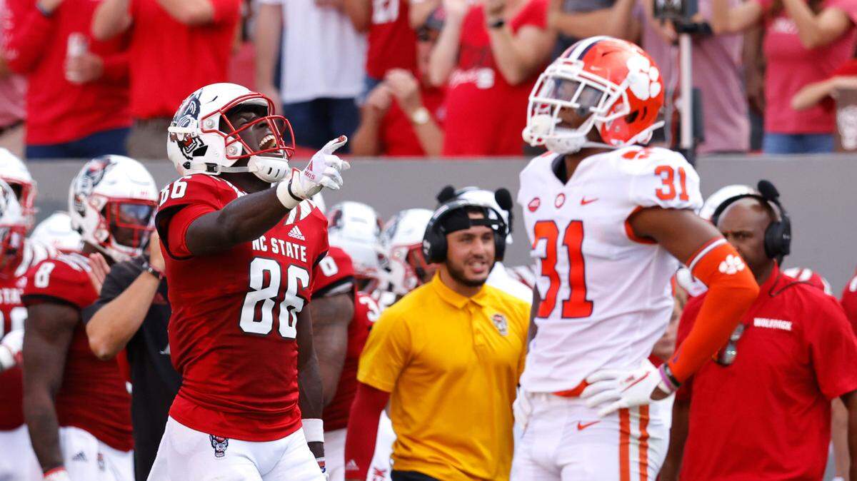 N.C. State wide receiver Emeka Emezie (86) celebrates after Clemson was penalized during the first half of N.C. State’s game against Clemson at Carter-Finley Stadium in Raleigh, N.C., Saturday, Sept. 25, 2021. Clemson cornerback Mario Goodrich (31) is to the right.