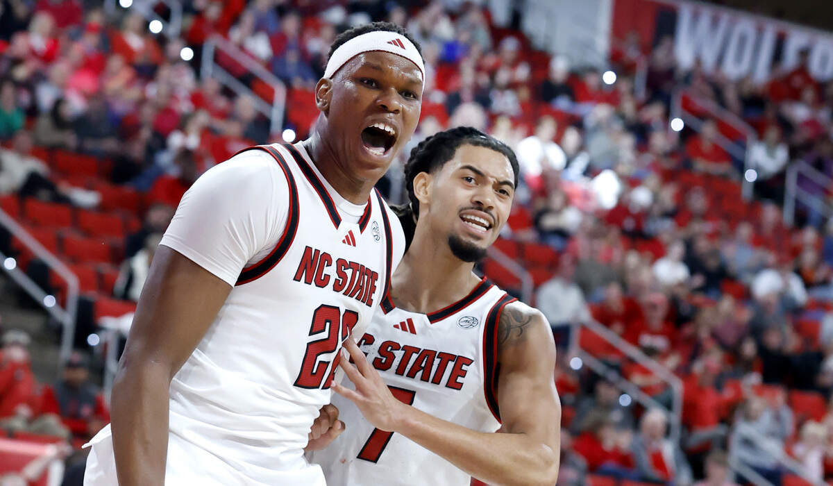 N.C. State's Ven-Allen Lubin (22) celebrates with Alyn Breed (7) after Lubin slammed in two during the second half of N.C. State’s 75-63 victory over UNC Asheville at the Lenovo Center in Raleigh, N.C., Saturday, Dec. 6, 2025.
