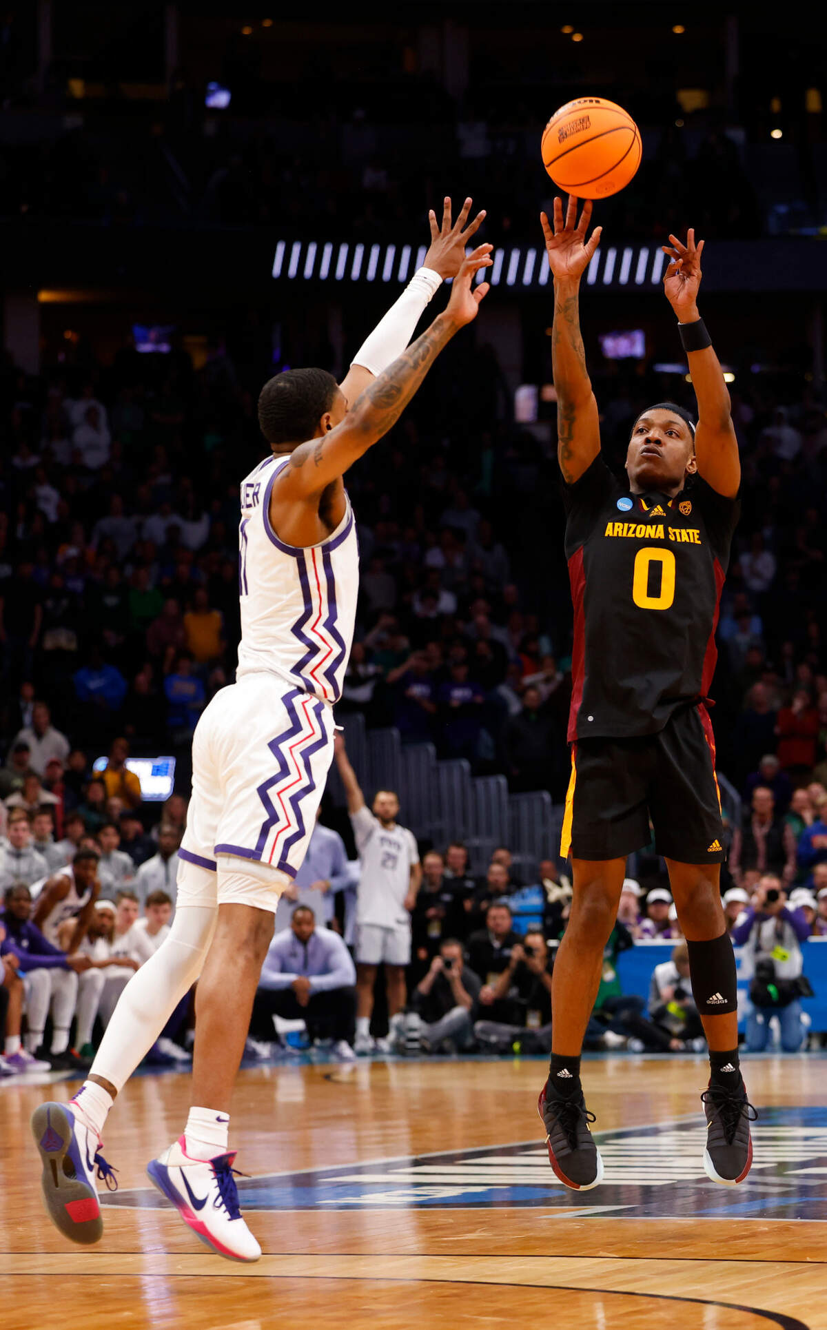 Arizona State Sun Devils guard DJ Horne (0) makes a game tying shot late in the second half over TCU Horned Frogs guard Rondel Walker (11) at Ball Arena.