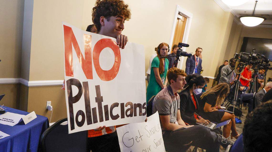 University of Florida political science student Giancarlo Rodriguez, 20, of Orlando, left, joins Ashley Sanguine, 19, of Miami, who is seated, as they protest Sen. Ben Sasse while he answers questions by the university’s board of trustees on Tuesday, Nov. 1, 2022, in Gainesville. (Ivy Ceballo/Tampa Bay Times/TNS)