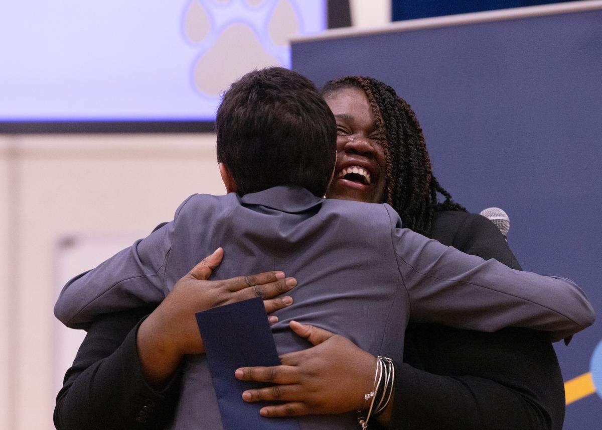 Pearsontown Elementary School Principal Asia Cunningham hugs Stephanie Bishop after receiving a Milken Educator Award on Friday, Nov. 3, 2023, in Durham, N.C.