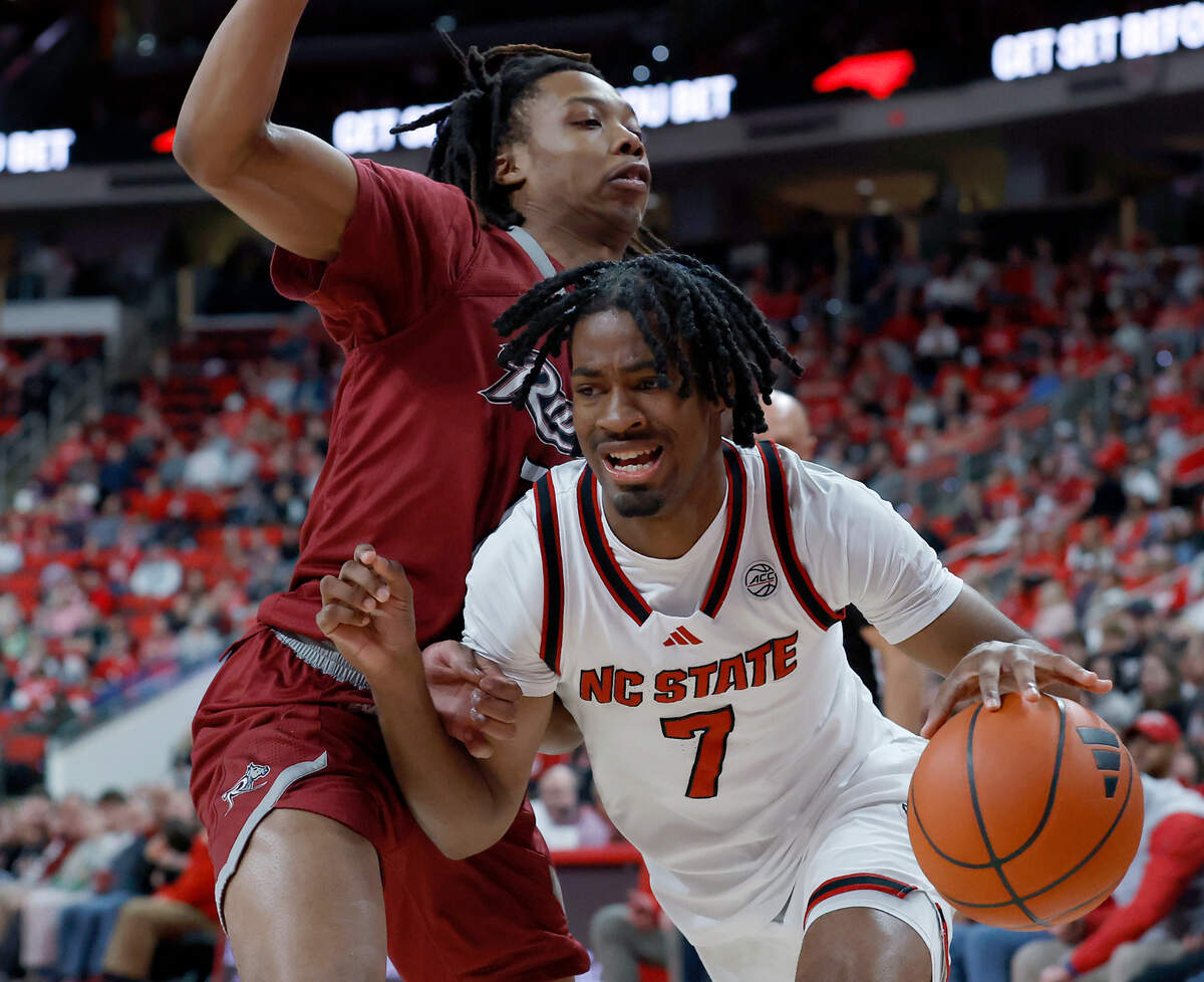 N.C. State’s Bryce Heard drives past Rider’s Ife West-Ingram during the first half of the Wolfpack’s 89-63 win on Sunday, Dec. 22, 2024, at Lenovo Center in Raleigh, N.C.